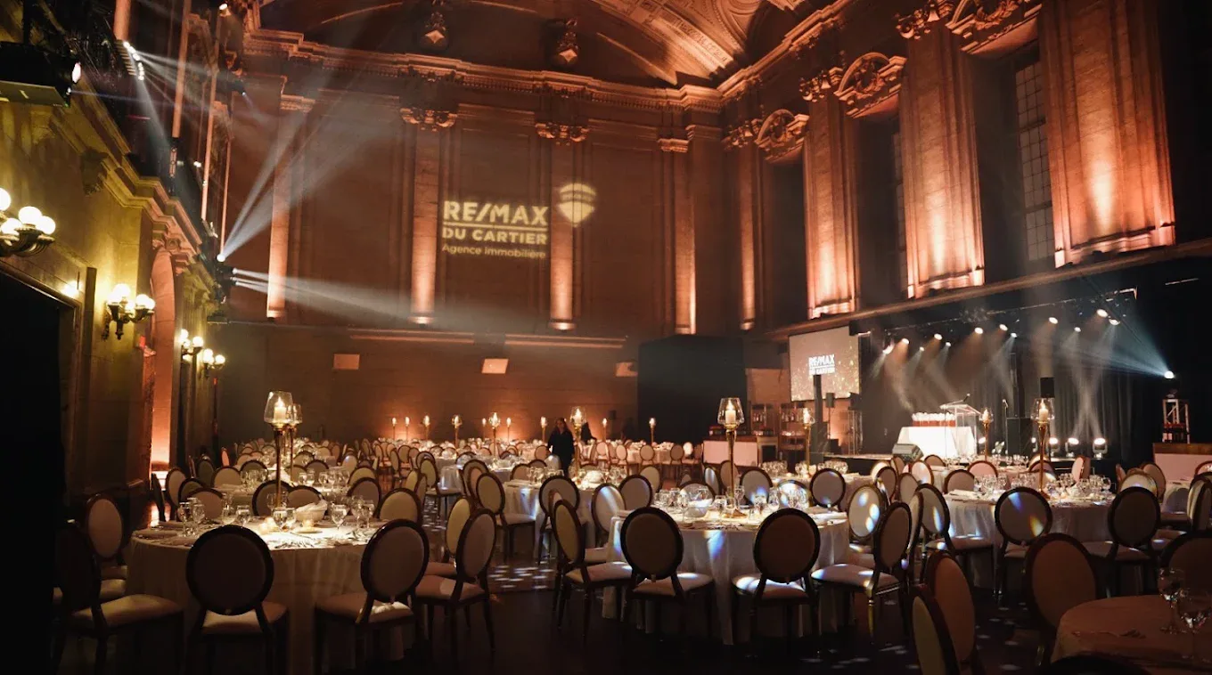 RE/MAX du Cartier gala at Théâtre St-James, gobo logo projected over a candlelit dinner room