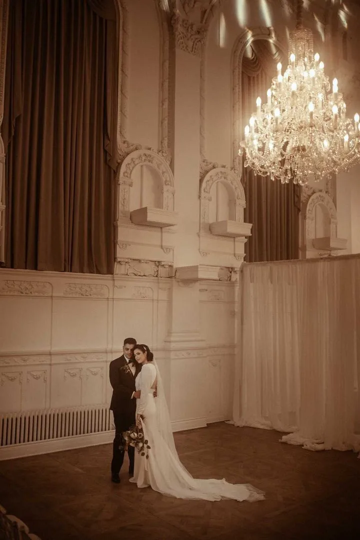 Couple in the grand hall at Maison Principale