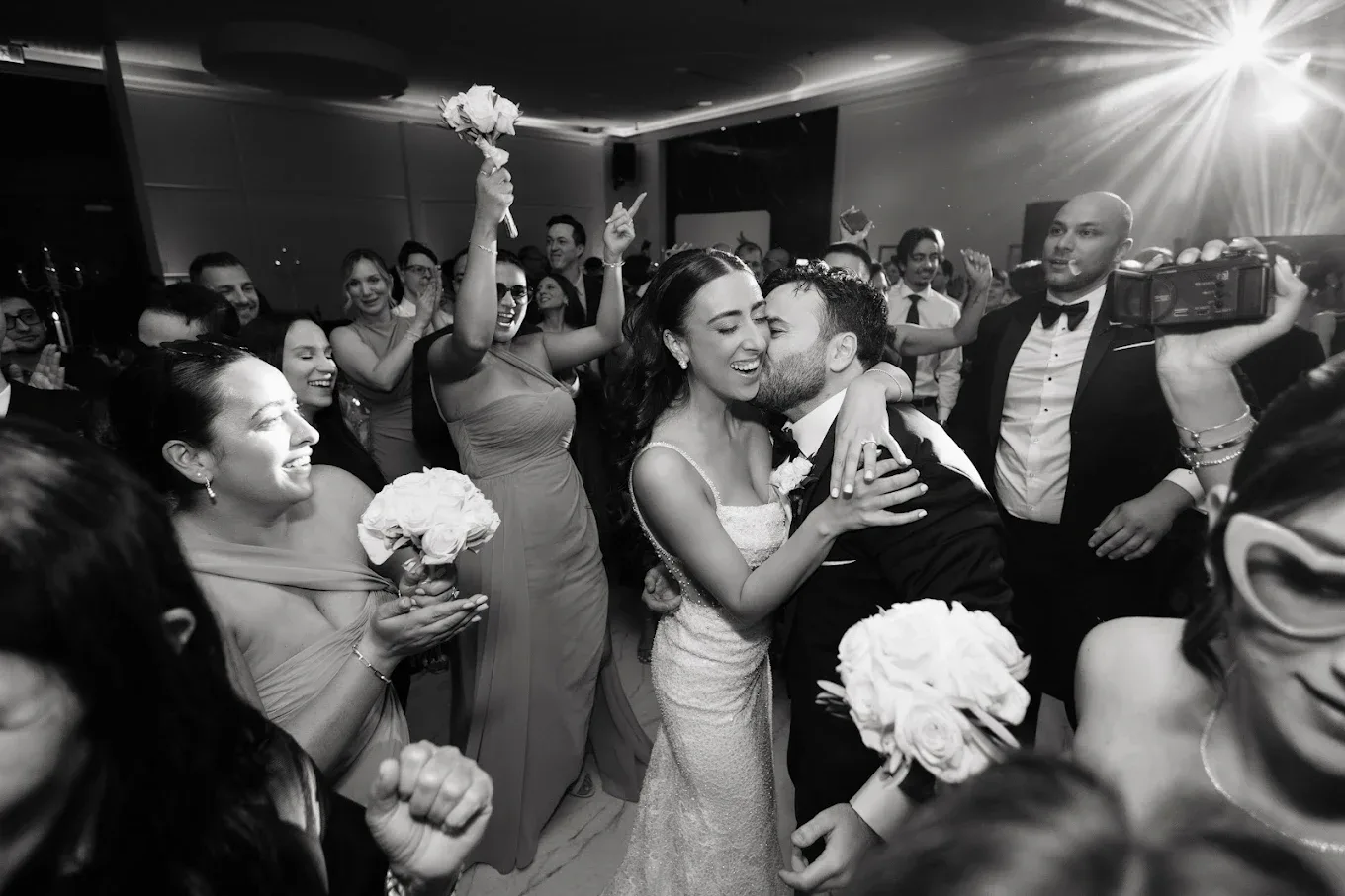 Couple kissing in a full dance floor crowd