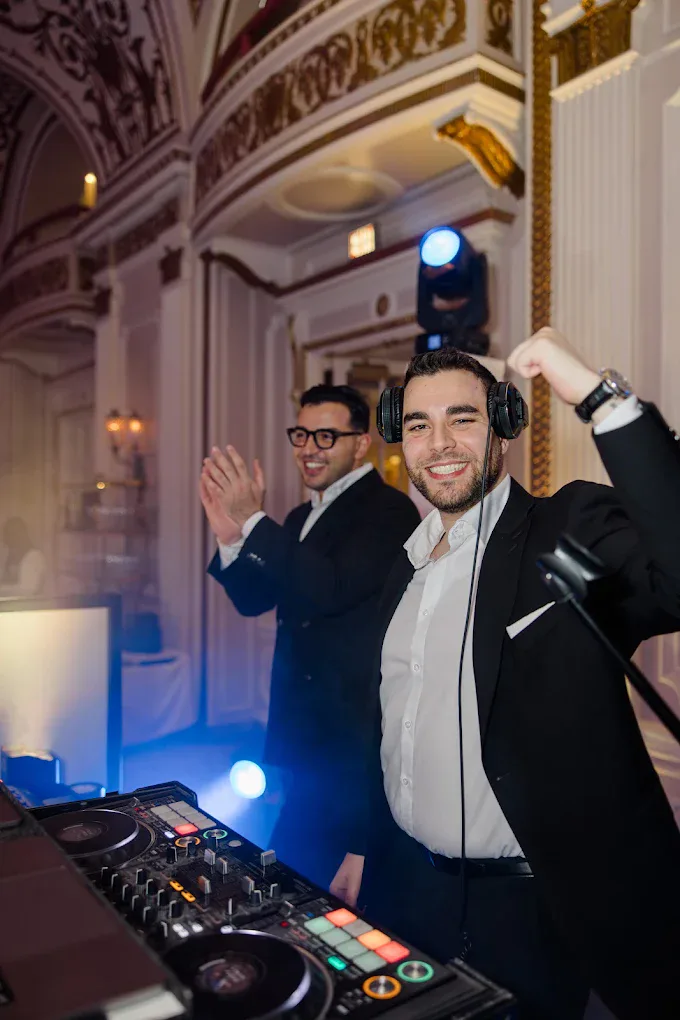 Kirky and Majd behind the decks at a wedding