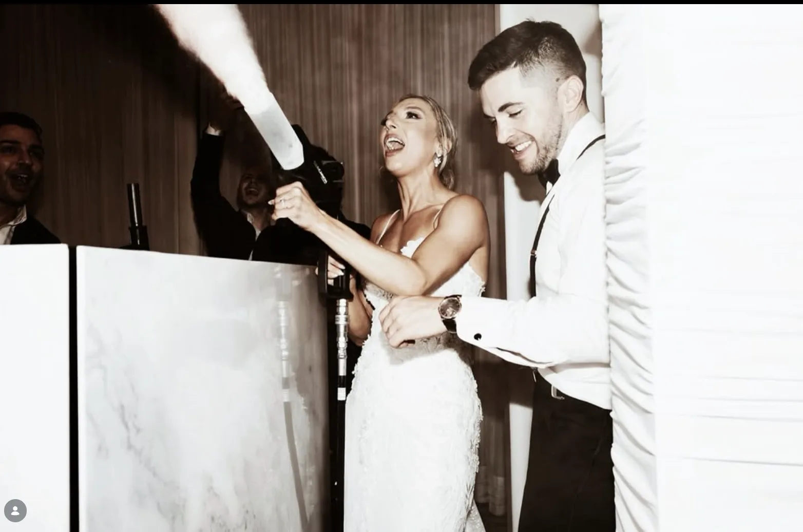 Couple firing a CO2 cannon from behind the DJ booth